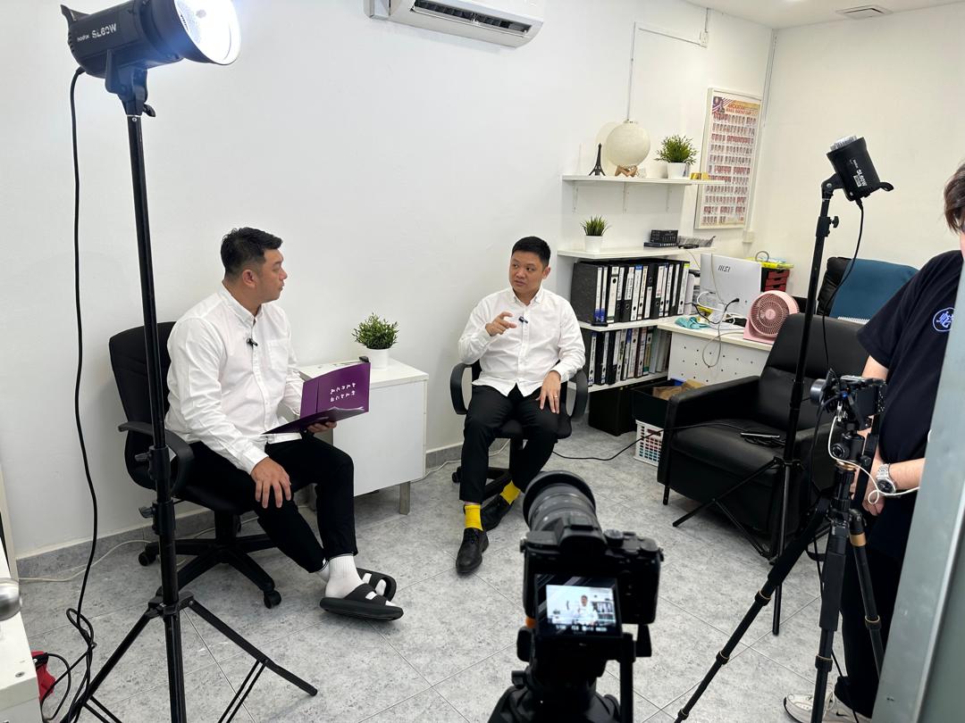Studio photography setup with lights, camera, and interview subjects